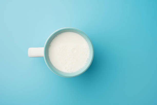 istock Cup with milk bubble foam on top view isolated t on blue background food drink object design 1140589437