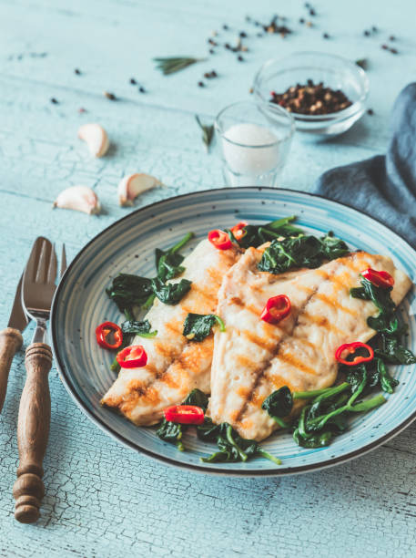 istock Grilled sea bream fish fillet with spinach 1140589440