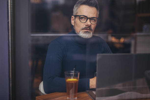 istock Mature man sitting in the coffee shop 1140589619