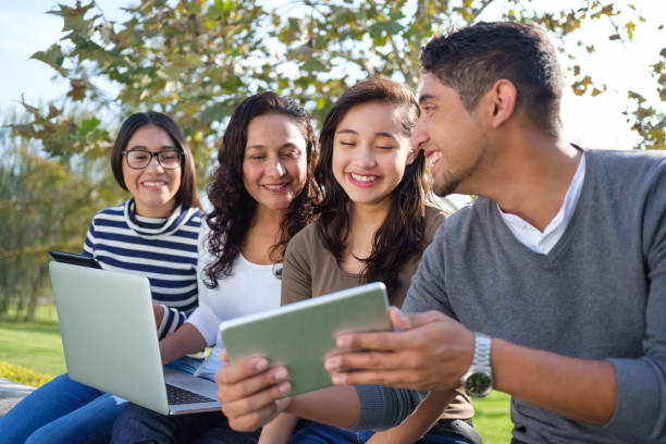 istock Young man sitting with family and using tablet 1140590626