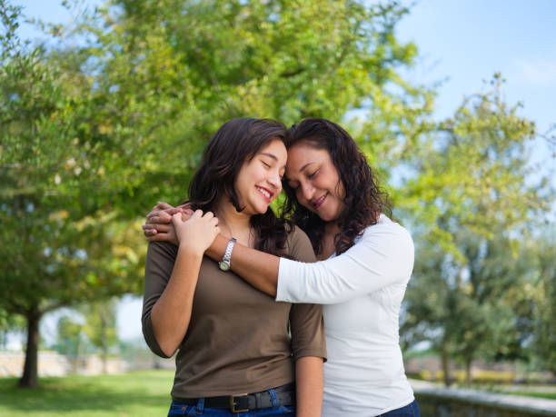 istock Affectionate mother and daughter standing together 1140590638