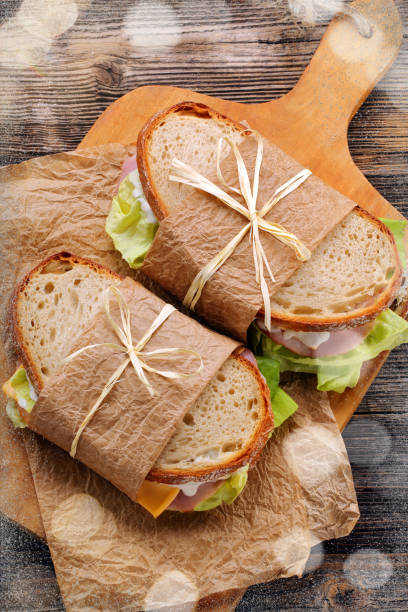 istock White bread sandwich with ham cheese and lettuce 1140592662