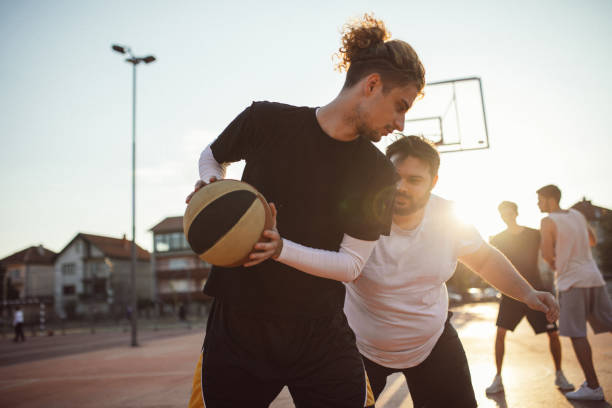 istock Men friends playing basketball 1140593289
