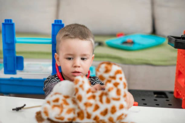 Boy kid playing doctor with toy