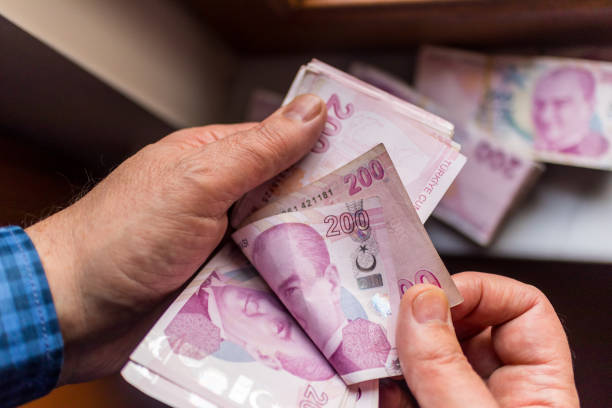 istock man counting 200 turkish lira banknote 1140593447