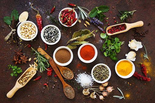 Spices and herbs on rustic background.