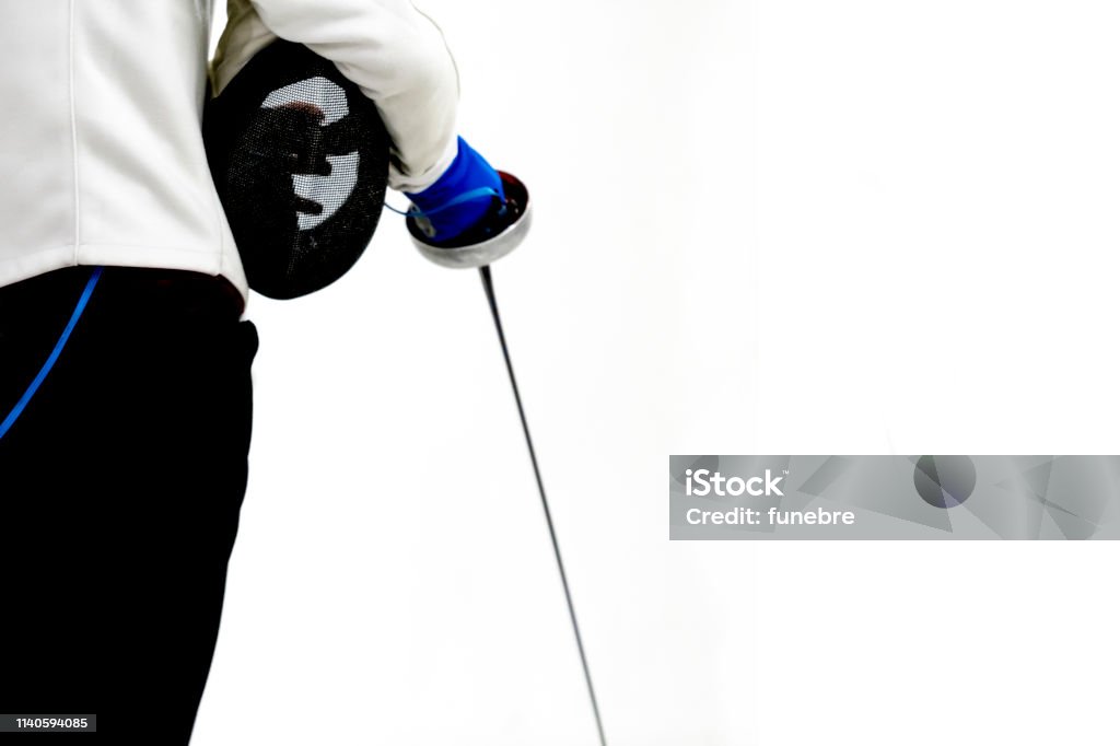 Male fencer hold epee and ferncer mask wearing white fencing costume isolated on white background Sport, Fencing - Sport, Foil Fencing - Sport, Adult Adult Stock Photo