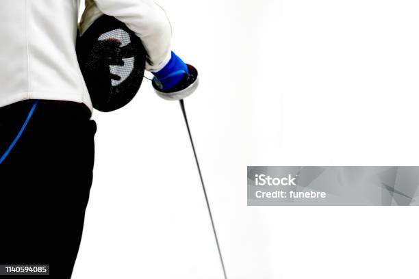 Male Fencer Hold Epee And Ferncer Mask Wearing White Fencing Costume Isolated On White Background Stock Photo - Download Image Now