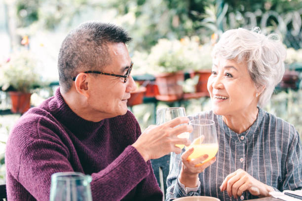 Asian Senior Couple eating outdoor and enjoying life Asian Senior Couple eating outdoor and enjoying life chinese ethnicity china restaurant eating stock pictures, royalty-free photos & images