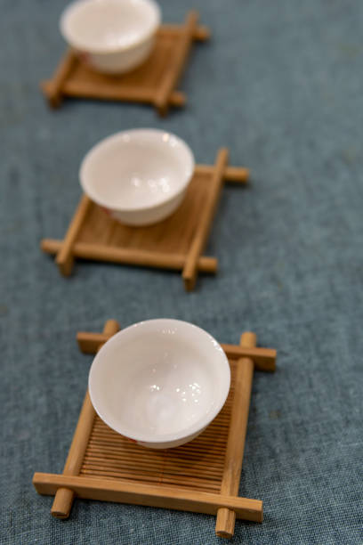 istock White Chinese tea cup on a wooden stand. 1140594439