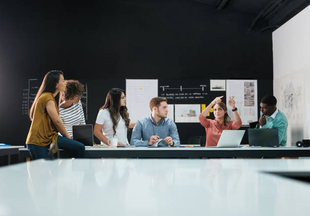 istock Young female employee raising her hands to explain a project 1140596443