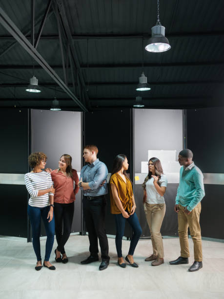 istock Multiethnic group of young professionals standing looking at each other 1140596463