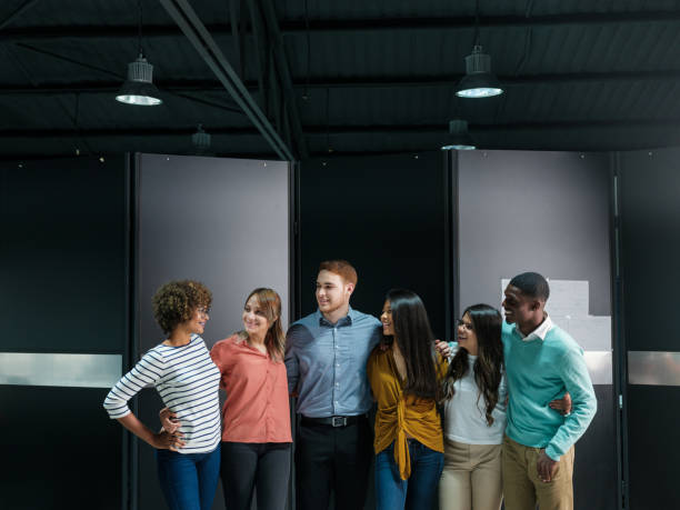 istock Team of young professionals standing closely together 1140596514