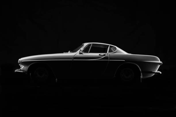 Model Volvo P1800 Beaconsfield, UK - October 3, 2018: A scale model of Volvo's P1800/1800S sports coupe, a genuine icon of the 1960's, sitting against a black background. volvo stock pictures, royalty-free photos & images