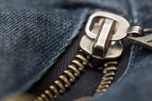 Close up and detailed shot of a metallic zip on denim
