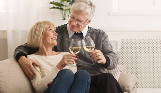istock Happy mature couple drinking white wine at home 1140602907