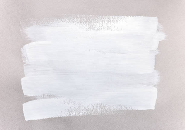 white acrylic paint brush strokes on beige paper texture