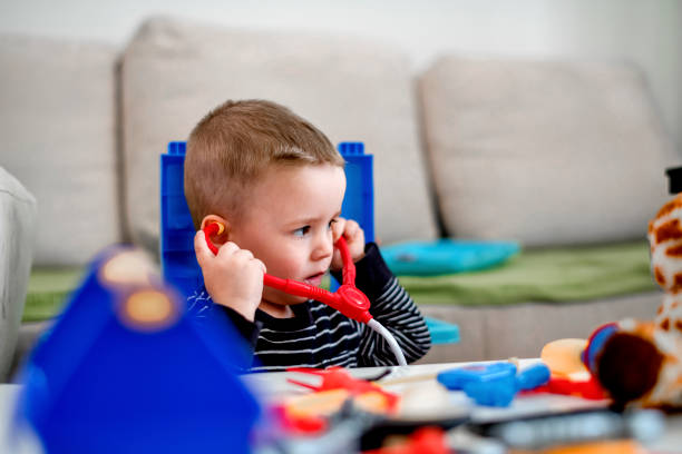 istock Boy kid playing doctor with toy 1140606169
