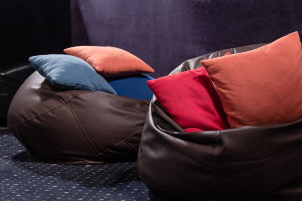 Leather beanbags with pillows. Cinema of open space office stock photo