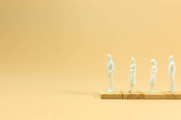 istock white  figure miniature on orange pastel for business content. 1140607998