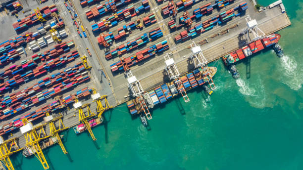 istock Container ship in export and import business logistics and transportation. Cargo and container box shipping to harbor by crane. Water transport International. Aerial view and top view. 1140608136