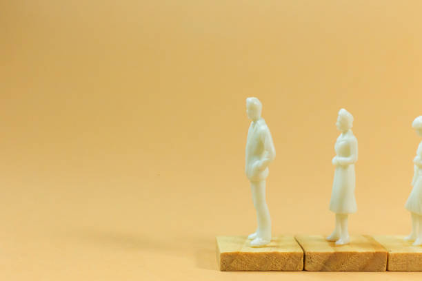 istock white  figure miniature on orange pastel for business content. 1140608140