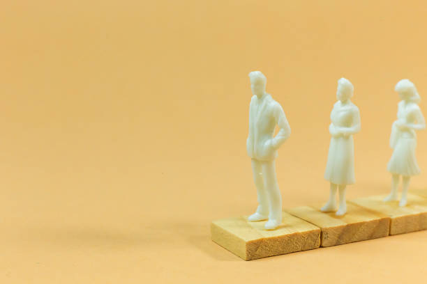istock white  figure miniature on orange pastel for business content. 1140608154