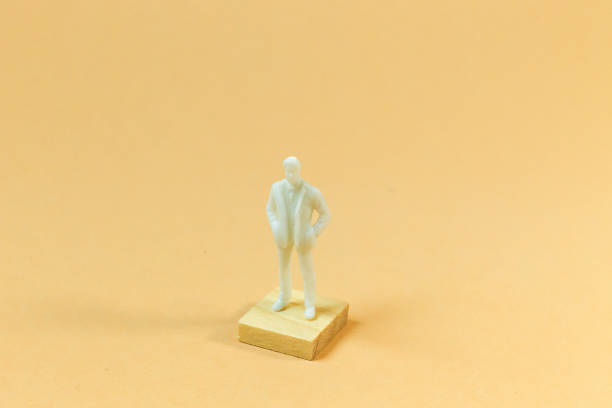 istock white  figure miniature on orange pastel for business content. 1140608277