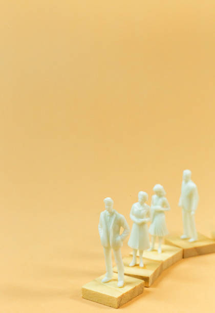 istock white  figure miniature on orange pastel for business content. 1140608299
