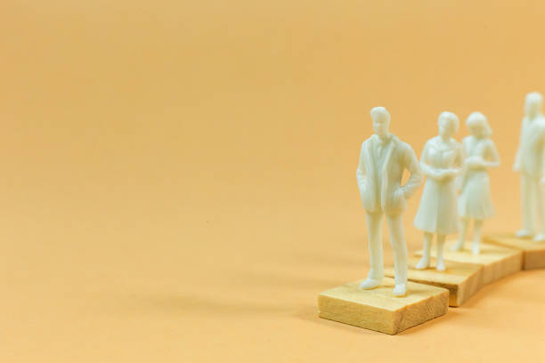 istock white  figure miniature on orange pastel for business content. 1140608323