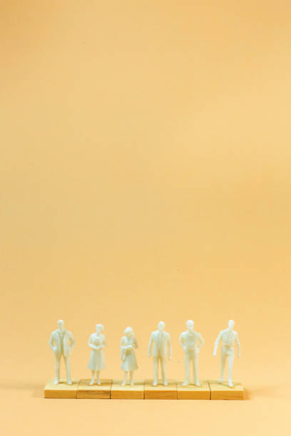 istock white  figure miniature on orange pastel for business content. 1140608582
