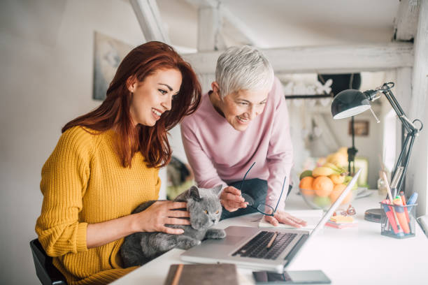 istock Women using laptop and holding a cat 1140608622