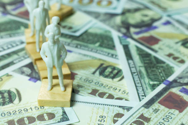 istock figure human and  100 dollar banknote  business content. 1140608756