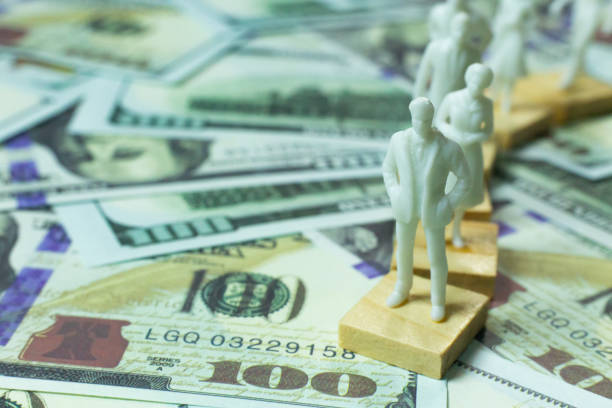 istock figure human and  100 dollar banknote  business content. 1140608763