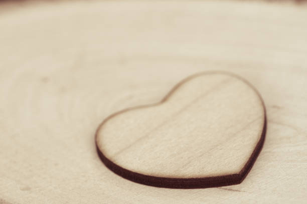istock wooden heart on wooden background texture macro 1140609524