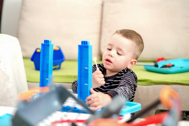 istock Little boy playing with toys 1140610140