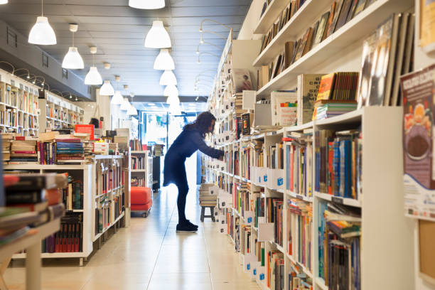 istock Organizing the shelf in the bookstore 1140610269
