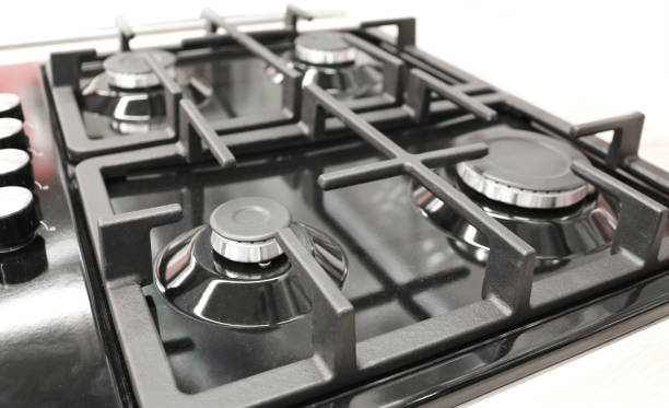 istock New modern gas stove with four burners for the kitchen, black enamelled surface 1140610404