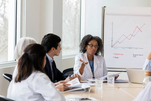 istock Concerned doctor meets with staff and administration 1140610937