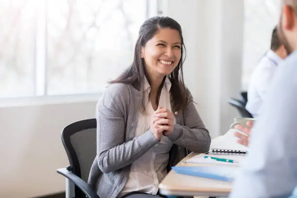 Photo of Smiling businesswoman interviews job candidate