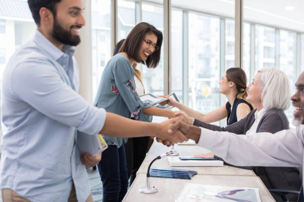 The meet and greet time was enjoyable After the conference, participants had and opportunity to speak to the panelists and pick up brochures containing more information. integration summit stock pictures, royalty-free photos & images