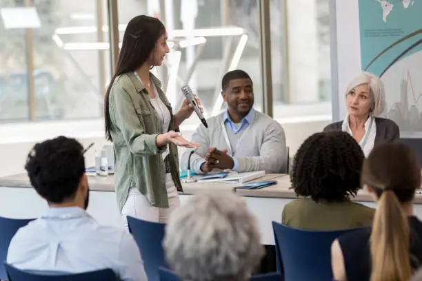 Photo of A young woman asks a question