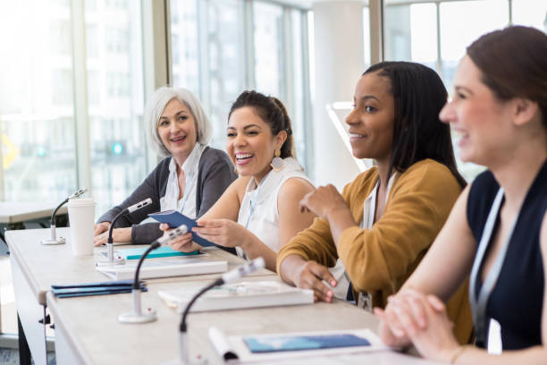 A panel of women present information