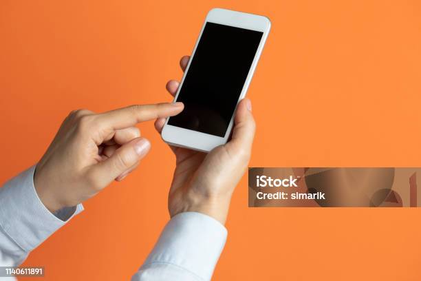 Using A Phone Background Using Phone Stock Photo - Download Image Now - Orange Color, Telephone ...