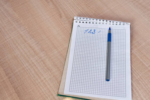 istock Ballpoint pen in a notebook on a brown background. Office. notebook and ballpoint pen on the table 1140613930