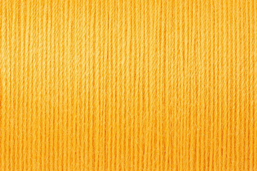 Macro picture of pastel yellow thread texture surface background