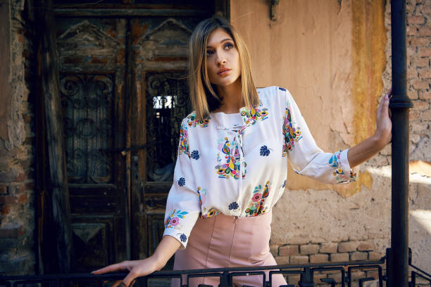 istock Young woman posing outdoors in colorful clothes 1140617333