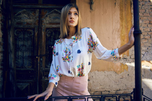 istock Young woman posing outdoors in colorful clothes 1140618288