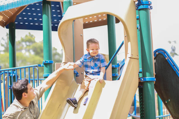 istock Little boy, father playing at local park. 1140620618