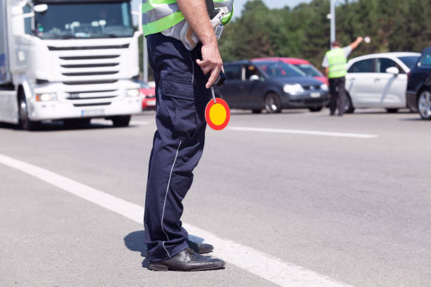 Police officer controlling traffic on the highway stock photo
